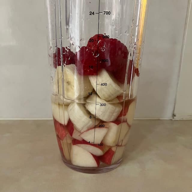 Apple Berry Banana Smoothie ingredients in a blender